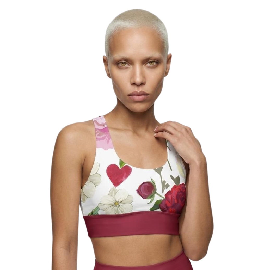 Model wearing roses of grace longline sports bra front view with floral design and red band