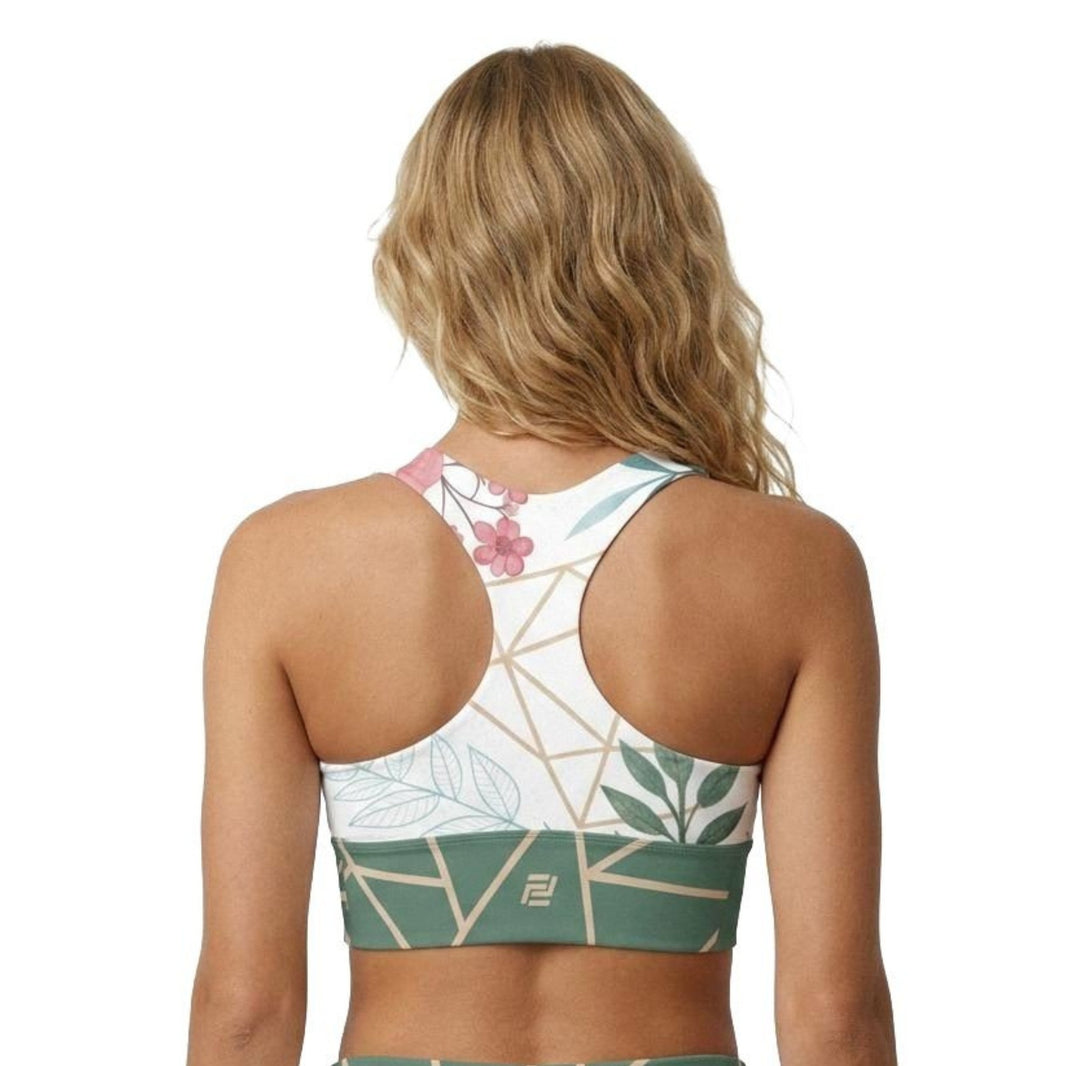 Model shown from the back wearing work of art sports bra with a floral pattern and green geometric band
