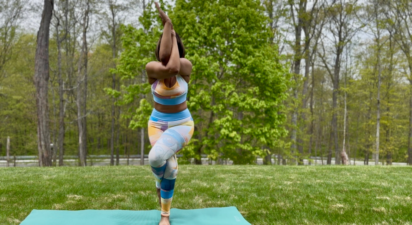 woman practicing yoga wearing dear human behind me matching workout set