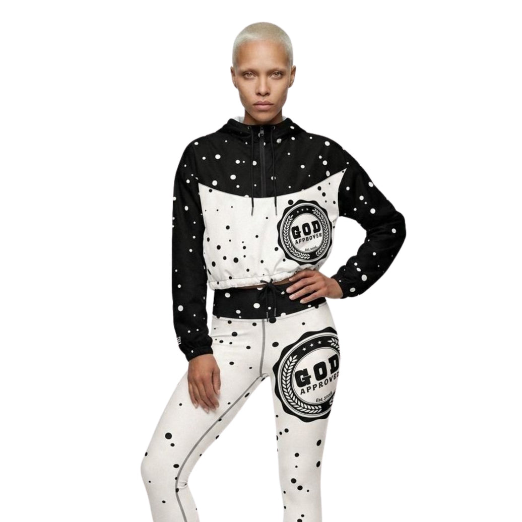 Model wearing God Approved Cropped Windbreaker in Black with matching workout leggings. Has Polka dot design in black and creme