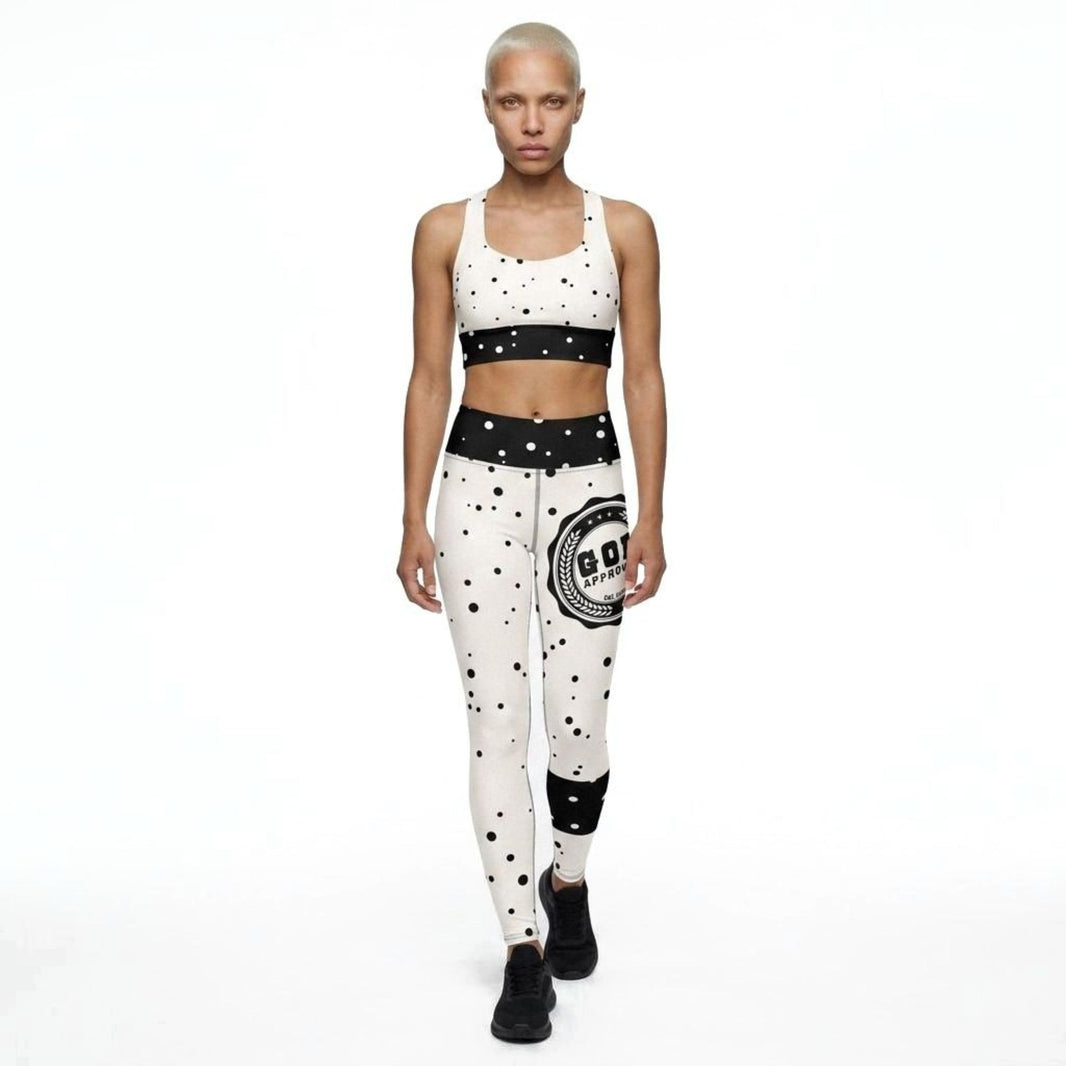 Model wearing God Approved matching activewear set consisting of a sports bra and leggings, with polka dot pattern and God Approved stamp