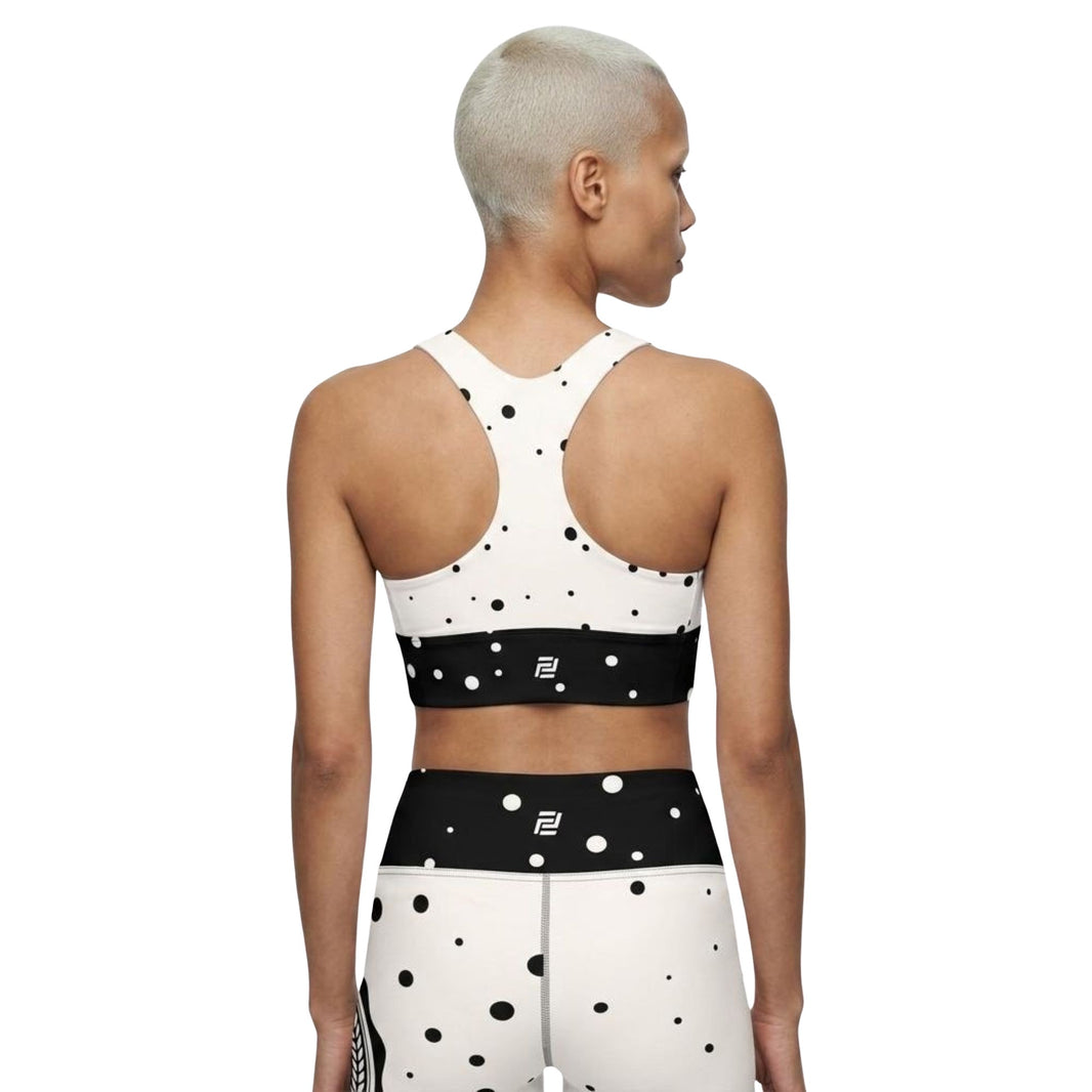 Model shown from the back wearing God Approved  sports bra and matching leggings set with a polka dot pattern