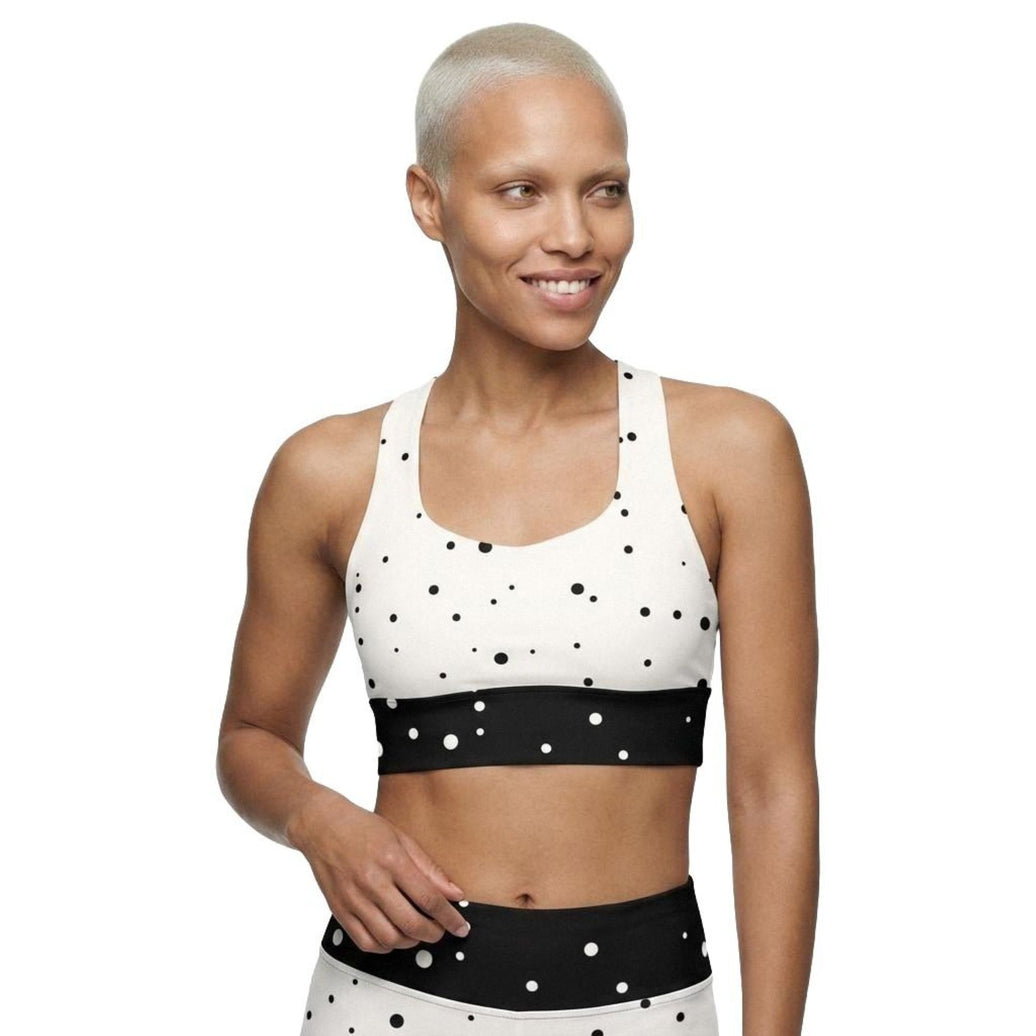 Model wearing God Approved longline sports bra front view with polka dot design