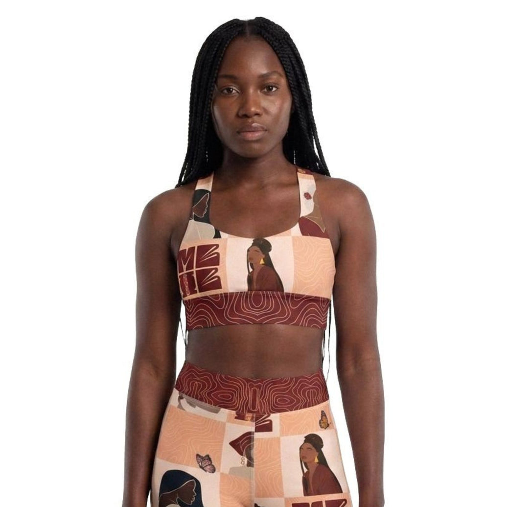 Model wearing My Black Is Beautiful longline sports bra front view with black woman design and red accents