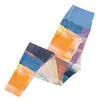 Vision unfolding abstract leggings with vibrant colors, eco-friendly women’s activewear left folded view