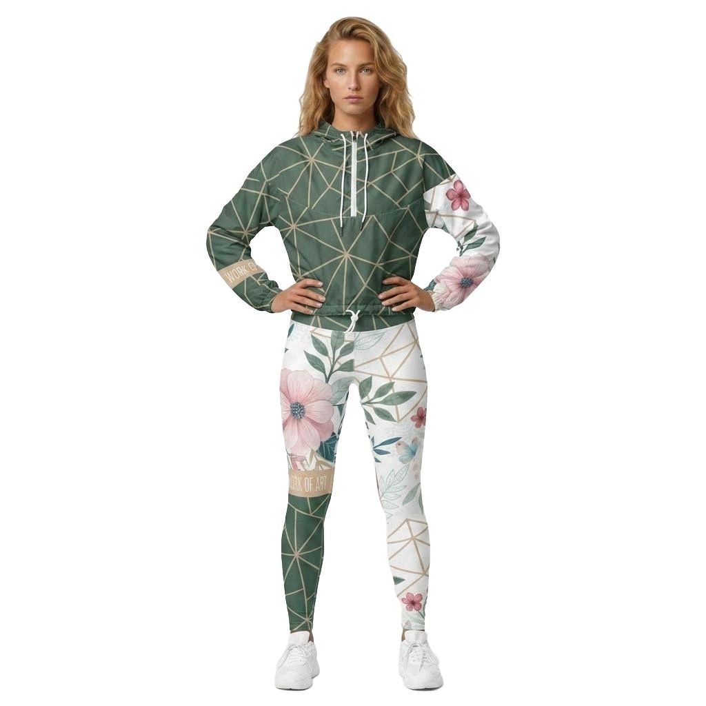 Model wearing Work of Art Cropped Windbreaker in Green with matching workout leggings. Has floral design and geometric accents in green.