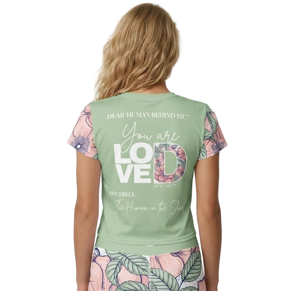 Model wearing Dear Human Behind Me Msg 1, You Are Loved Crop top in green with floral design, back view