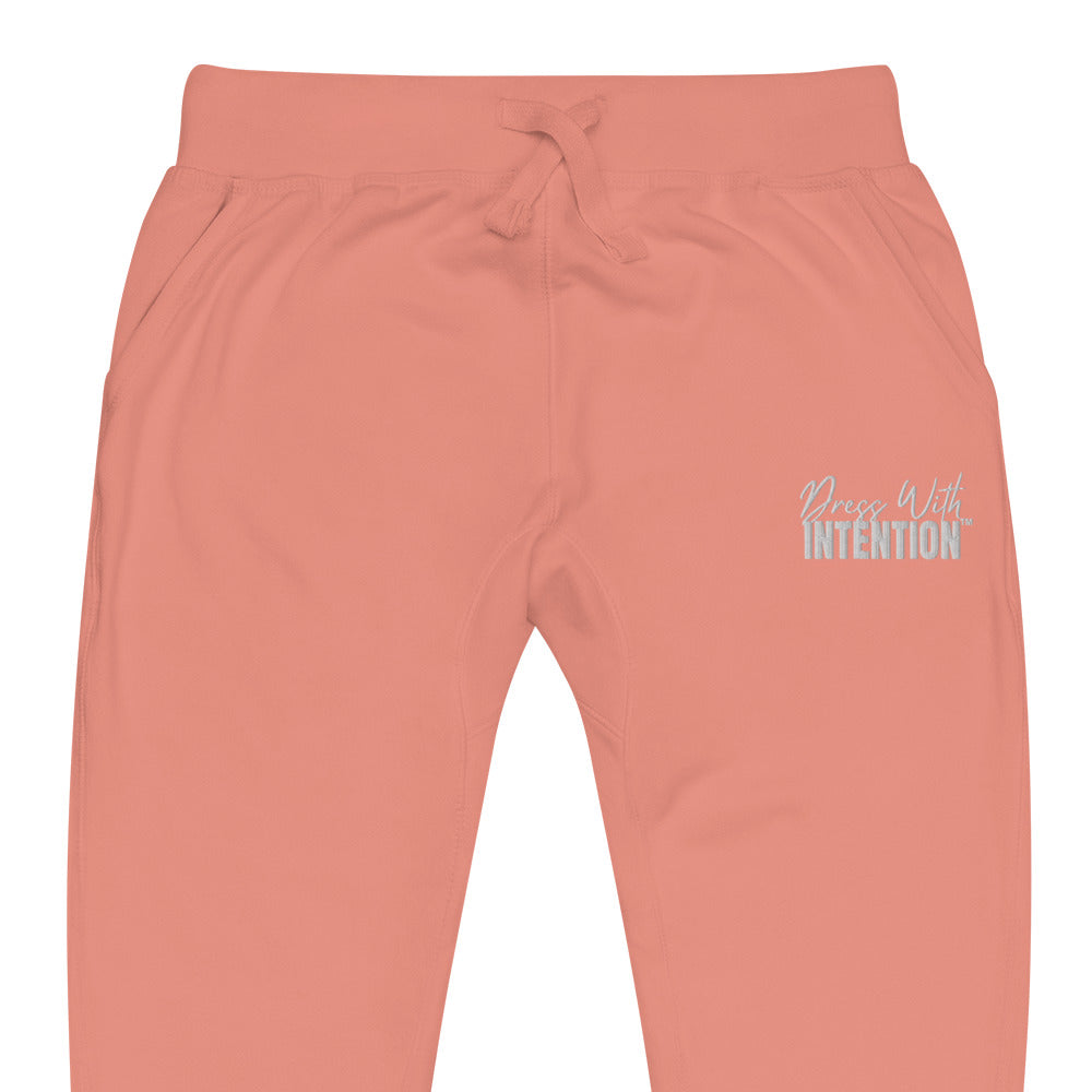 Zoomed in front view of "Dress With Intention" in white writing unisex joggers in dusty rose