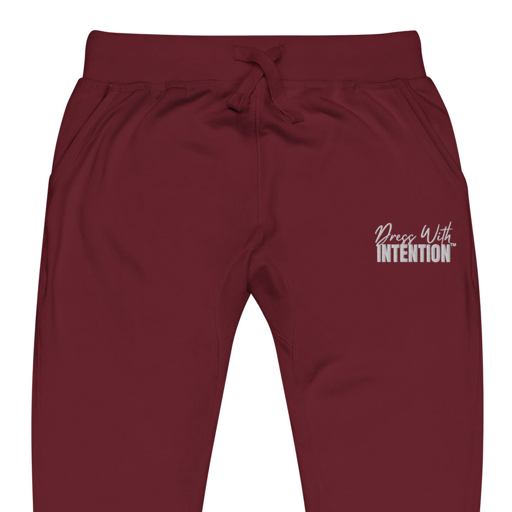 Zoomed in front view of "Dress With Intention" unisex joggers in maroon
