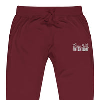 Zoomed in front view of "Dress With Intention" unisex joggers in maroon